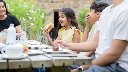 A family enjoying refreshments from the Brewhouse Café at Seaton Delaval Hall, Northumberland